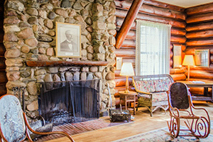 Stone fireplace and seating area inside Douglas Lodge at Itasca State Park